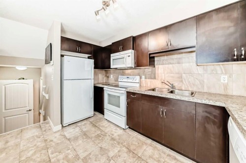 303-250 Sage Valley Road Nw, Calgary, AB - Indoor Photo Showing Kitchen With Double Sink