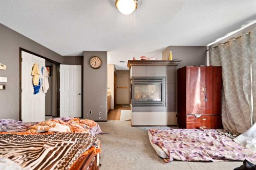 34 Brightoncrest Common Se, Calgary, AB - Indoor Photo Showing Bedroom With Fireplace