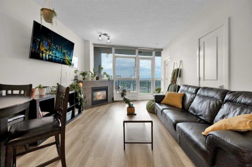 2203-77 Spruce Place Sw, Calgary, AB - Indoor Photo Showing Living Room With Fireplace