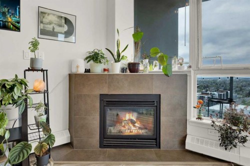 2203-77 Spruce Place Sw, Calgary, AB - Indoor Photo Showing Living Room With Fireplace