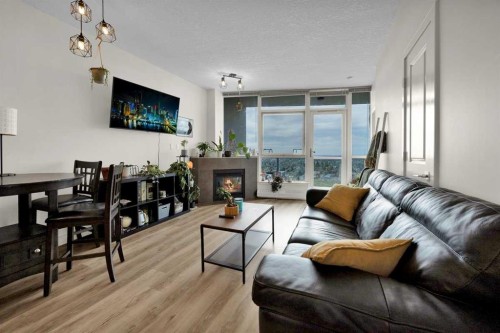 2203-77 Spruce Place Sw, Calgary, AB - Indoor Photo Showing Living Room With Fireplace