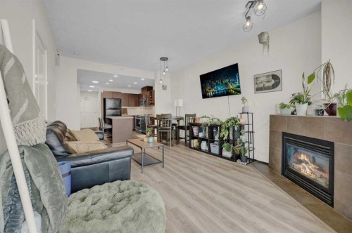 2203-77 Spruce Place Sw, Calgary, AB - Indoor Photo Showing Living Room With Fireplace