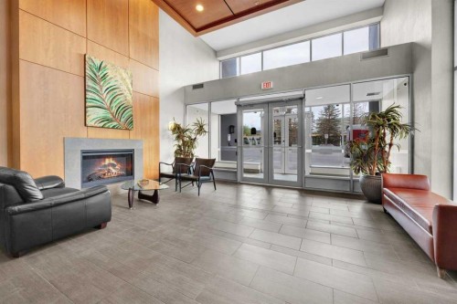 2203-77 Spruce Place Sw, Calgary, AB - Indoor Photo Showing Other Room With Fireplace