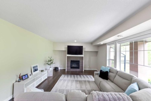 165 Cranbrook Villas Se, Calgary, AB - Indoor Photo Showing Living Room With Fireplace