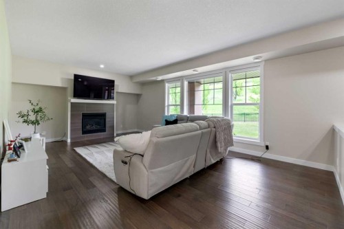 165 Cranbrook Villas Se, Calgary, AB - Indoor Photo Showing Living Room With Fireplace