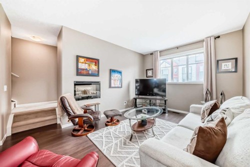 205 Copperpond Row Se, Calgary, AB - Indoor Photo Showing Living Room With Fireplace
