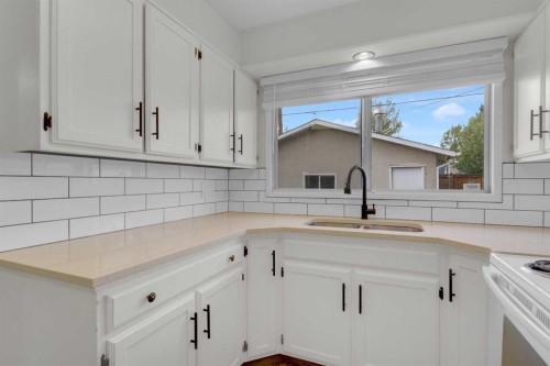 452 Queen Alexandra Way Se, Calgary, AB - Indoor Photo Showing Kitchen With Double Sink