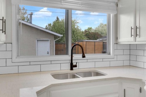 452 Queen Alexandra Way Se, Calgary, AB - Indoor Photo Showing Kitchen With Double Sink