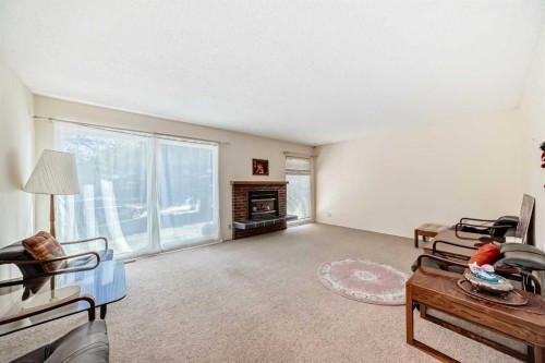 8 Varsdale Place Nw, Calgary, AB - Indoor Photo Showing Living Room With Fireplace