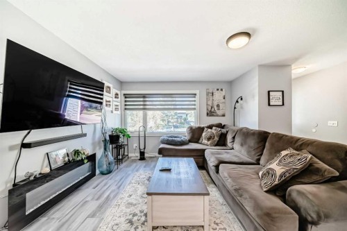 447 Malvern Close Ne, Calgary, AB - Indoor Photo Showing Living Room With Fireplace
