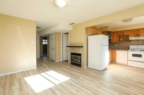 8-720 Heritage Boulevard West, Lethbridge, AB - Indoor Photo Showing Kitchen With Fireplace