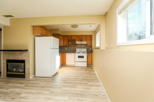 8-720 Heritage Boulevard West, Lethbridge, AB - Indoor Photo Showing Kitchen With Fireplace