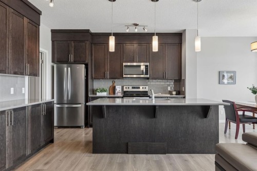 65 Fireside Crescent, Cochrane, AB - Indoor Photo Showing Kitchen With Stainless Steel Kitchen With Upgraded Kitchen