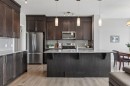 65 Fireside Crescent, Cochrane, AB  - Indoor Photo Showing Kitchen With Stainless Steel Kitchen With Upgraded Kitchen 