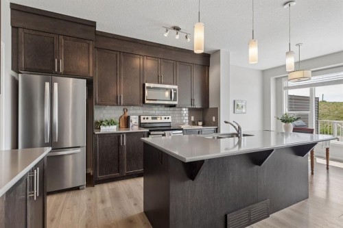 65 Fireside Crescent, Cochrane, AB - Indoor Photo Showing Kitchen With Stainless Steel Kitchen With Double Sink With Upgraded Kitchen