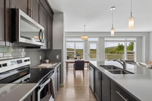 65 Fireside Crescent, Cochrane, AB - Indoor Photo Showing Kitchen With Stainless Steel Kitchen With Double Sink With Upgraded Kitchen