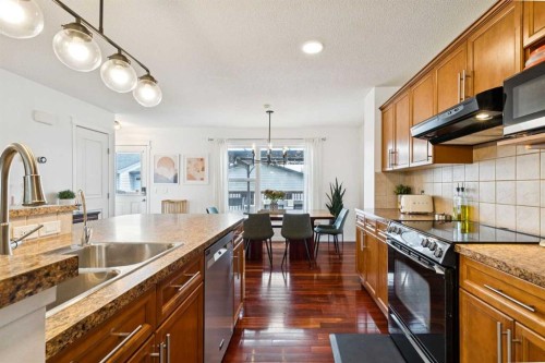 411 Silverado Drive Sw, Calgary, AB - Indoor Photo Showing Kitchen With Double Sink With Upgraded Kitchen
