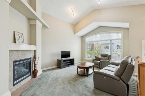 94 Panatella Close Nw, Calgary, AB - Indoor Photo Showing Living Room With Fireplace
