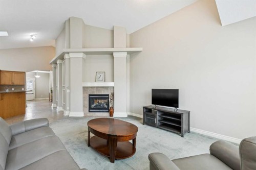 94 Panatella Close Nw, Calgary, AB - Indoor Photo Showing Living Room With Fireplace