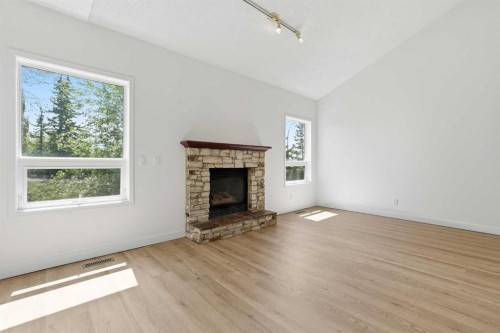 142 Elizabeth Way Se, Airdrie, AB - Indoor Photo Showing Living Room With Fireplace