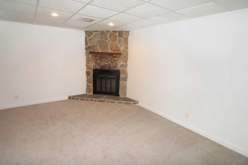 235 Avonburn Road Se, Calgary, AB - Indoor Photo Showing Other Room With Fireplace