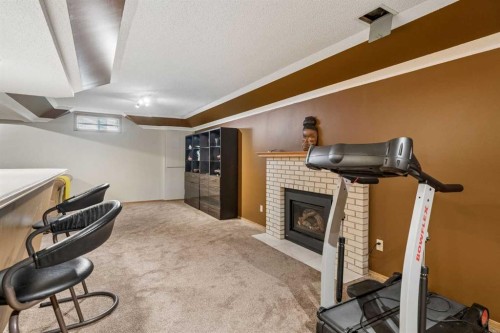 112 Oakbriar Close Sw, Calgary, AB - Indoor Photo Showing Other Room With Fireplace
