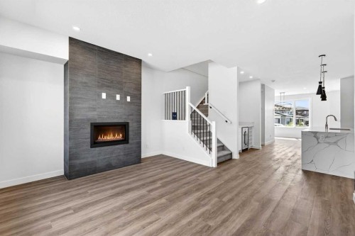 1109 Sailfin Heath, Rural Rocky View County, AB - Indoor Photo Showing Living Room With Fireplace