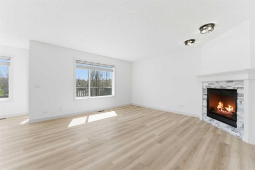 110 Tuscany Summit Green Nw, Calgary, AB - Indoor Photo Showing Living Room With Fireplace