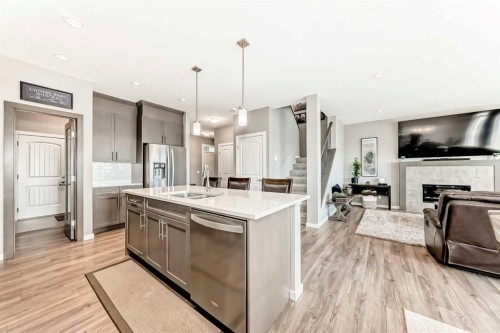 59 Heritage Heights, Cochrane, AB - Indoor Photo Showing Kitchen With Fireplace With Double Sink With Upgraded Kitchen
