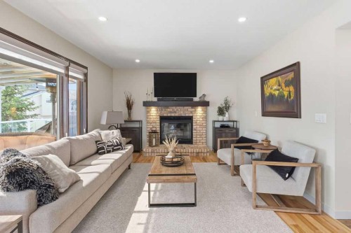 42 Evergreen Terrace Sw, Calgary, AB - Indoor Photo Showing Living Room With Fireplace