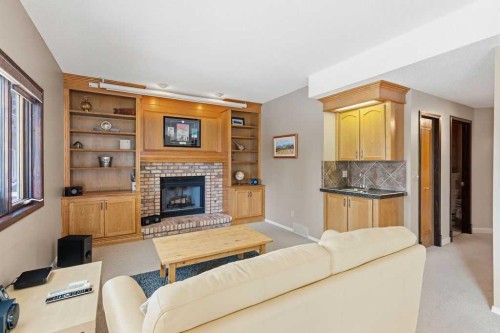 42 Evergreen Terrace Sw, Calgary, AB - Indoor Photo Showing Living Room With Fireplace