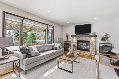 42 Evergreen Terrace Sw, Calgary, AB - Indoor Photo Showing Living Room With Fireplace