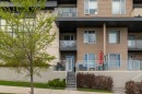 101-30 Shawnee Common Sw, Calgary, AB  - Outdoor With Balcony With Facade 
