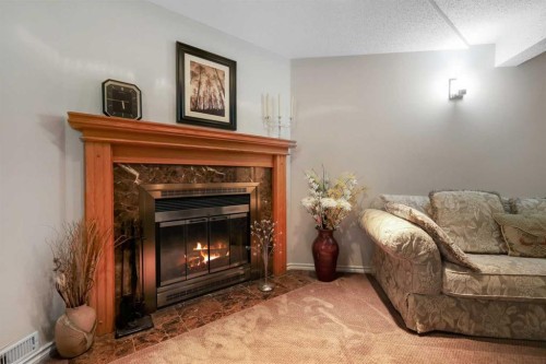 1296 Berkley Drive Nw, Calgary, AB - Indoor Photo Showing Living Room With Fireplace