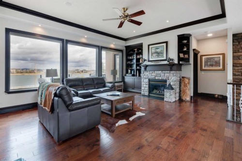 31 Montenaro Bay, Cochrane Lake, AB - Indoor Photo Showing Living Room With Fireplace
