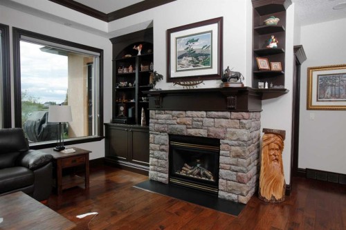 31 Montenaro Bay, Cochrane Lake, AB - Indoor Photo Showing Living Room With Fireplace