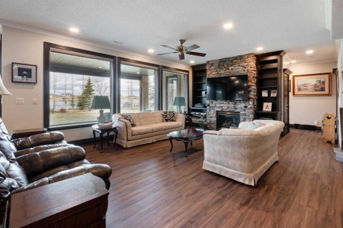 31 Montenaro Bay, Cochrane Lake, AB - Indoor Photo Showing Living Room With Fireplace