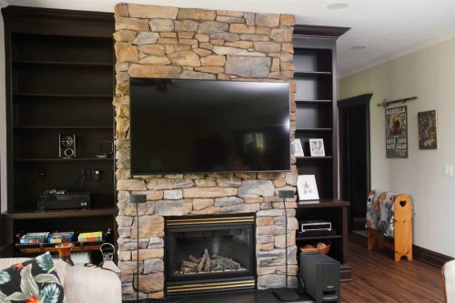 31 Montenaro Bay, Cochrane Lake, AB - Indoor Photo Showing Living Room With Fireplace