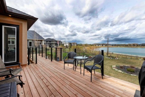 31 Montenaro Bay, Cochrane Lake, AB - Outdoor With Body Of Water With Deck Patio Veranda