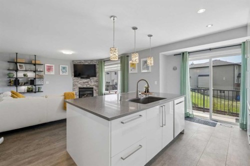 105 Royal Birch Crescent Nw, Calgary, AB - Indoor Photo Showing Kitchen With Fireplace