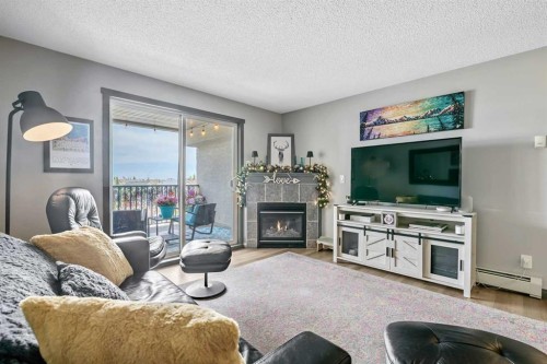 2307-12 Cimarron Common, Okotoks, AB - Indoor Photo Showing Living Room With Fireplace