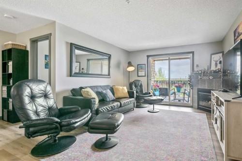 2307-12 Cimarron Common, Okotoks, AB - Indoor Photo Showing Living Room With Fireplace
