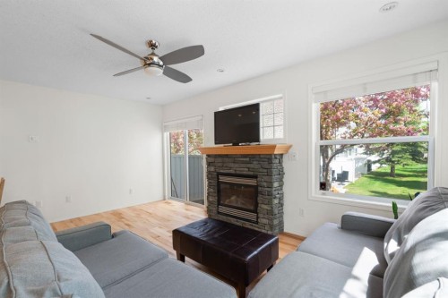 10 Eversyde Court Sw, Calgary, AB - Indoor Photo Showing Living Room With Fireplace