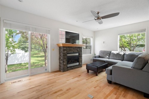 10 Eversyde Court Sw, Calgary, AB - Indoor Photo Showing Living Room With Fireplace