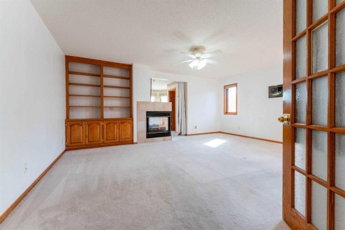 117 Evergreen Place Sw, Calgary, AB - Indoor Photo Showing Other Room With Fireplace