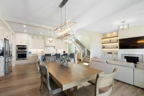 143 Marina Landing Se, Calgary, AB - Indoor Photo Showing Dining Room With Fireplace