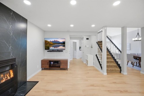 158 Shawbrooke Green Sw, Calgary, AB - Indoor Photo Showing Other Room With Fireplace
