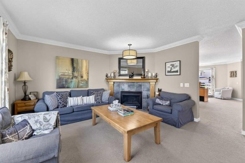185 Shawbrooke Green Sw, Calgary, AB - Indoor Photo Showing Living Room With Fireplace