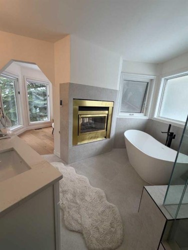 113 Straddock Terrace Sw, Calgary, AB - Indoor Photo Showing Living Room With Fireplace