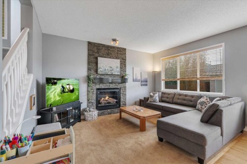 104 Prestwick Street Se, Calgary, AB - Indoor Photo Showing Living Room With Fireplace